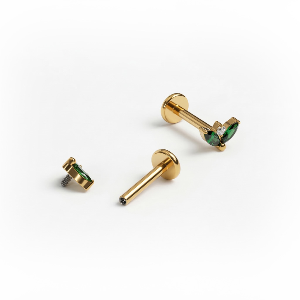 Titanová labreta s dvojicí smaragdových kamínků